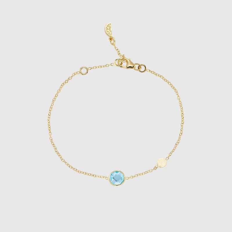 Geometric - Shaped Bangles in Matte Black for a Minimalist AestheticSalina Blue Topaz and Gold Disc Bracelet