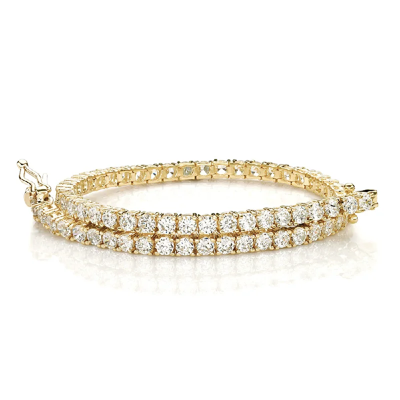 Clear Crystal - Embellished Bangles for a Sparkling and Elegant AppearanceRound Brilliant tennis bracelet with 4.02 carats* of diamond simulants in 10 carat yellow gold